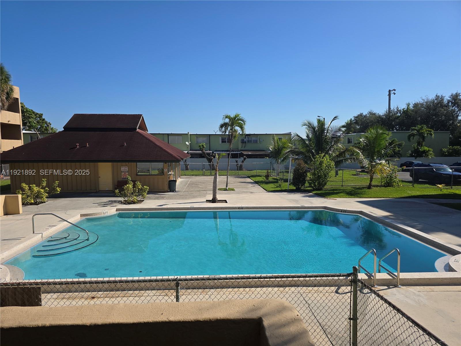 1750 West 56th Street, Unit 216 Hialeah, FL 33012 - Photo 14 of 14 a view of swimming pool with outdoor seating and plants