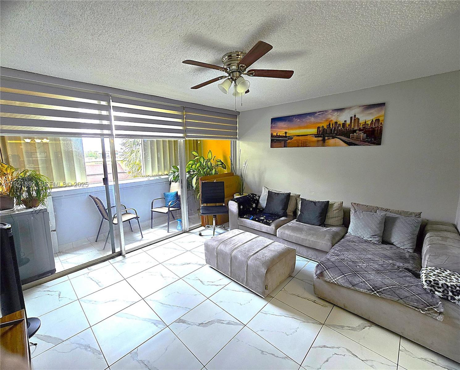 1750 West 56th Street, Unit 216 Hialeah, FL 33012 - Photo 3 of 14 a living room with furniture and a large window