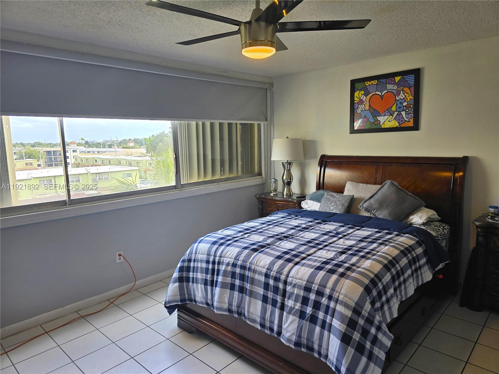 1750 West 56th Street, Unit 216 Hialeah, FL 33012 - Photo 6 of 14 a bedroom with a bed and a window