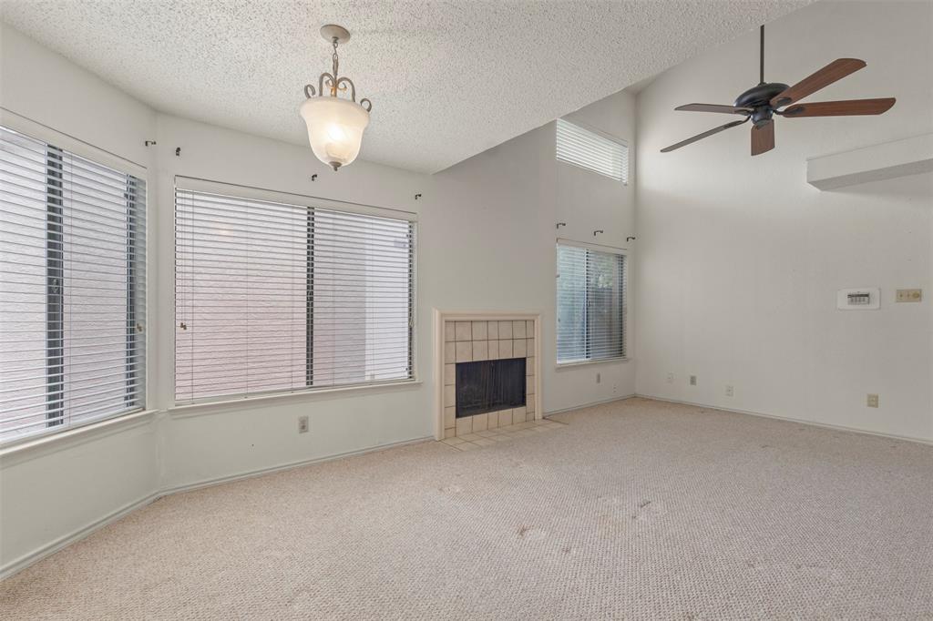 563 Ranch Trail, Unit 217 Irving, TX 75063 - Photo 3 of 19 a view of empty room with fireplace and windows