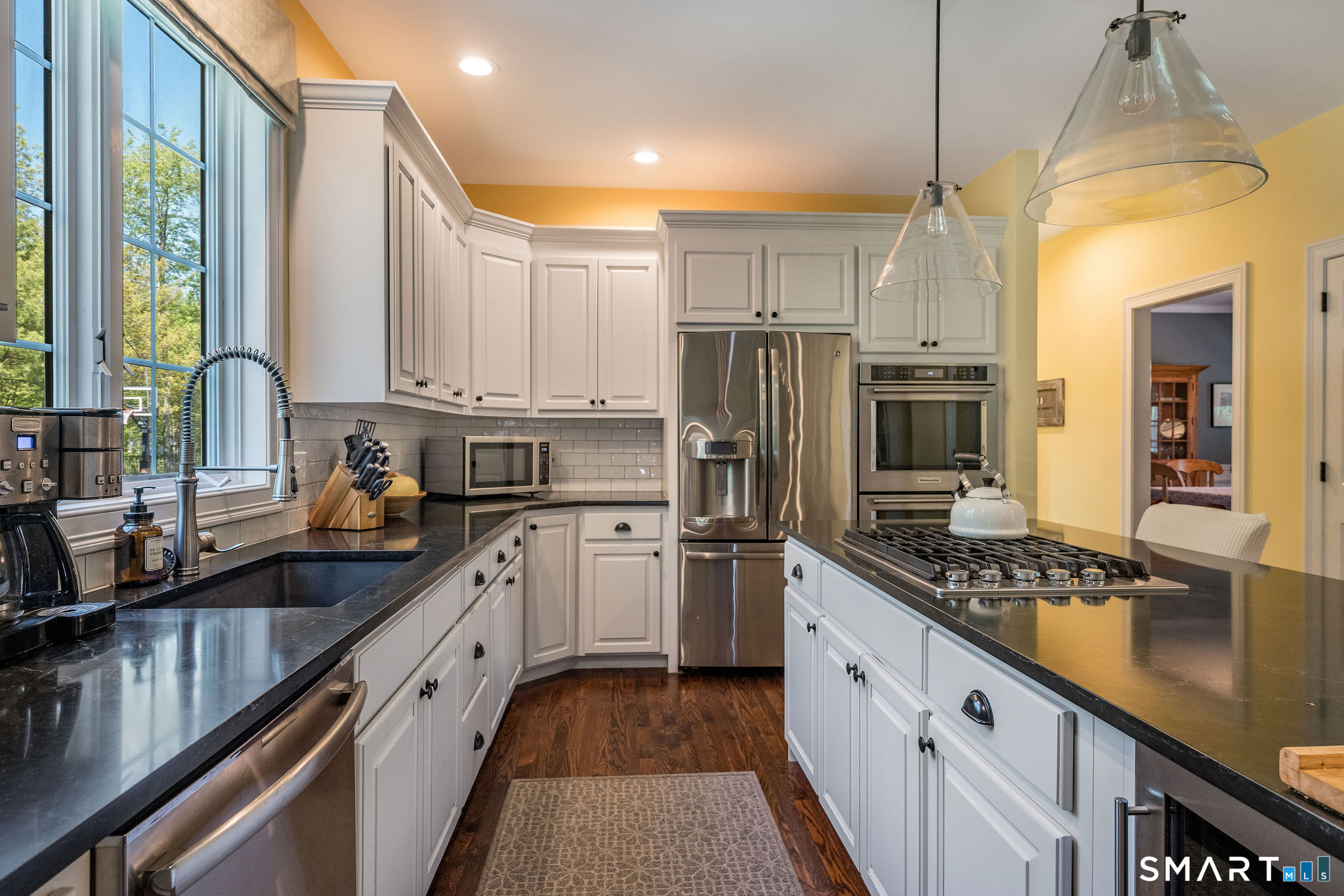 170 Devonshire Lane Madison, CT 06443 - Photo 8 of 39 a kitchen with stainless steel appliances a refrigerator sink and stove