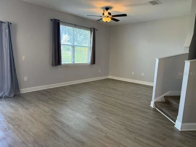wooden floor in an empty room with a window