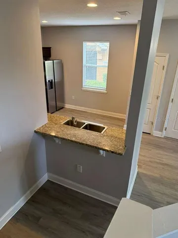 a view of kitchen island wooden floor and wooden floor