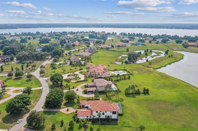 an aerial view of residential houses with outdoor space and river