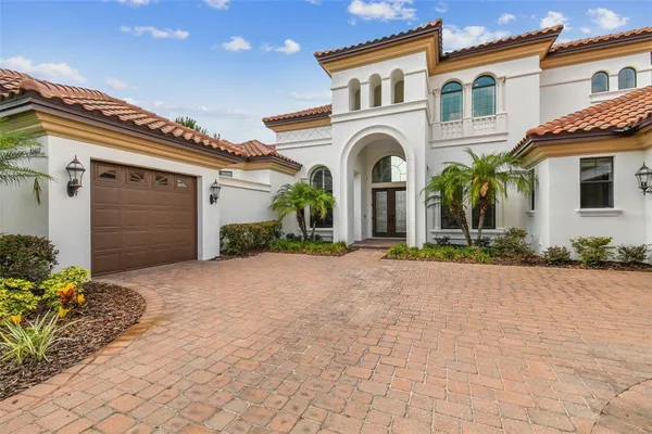 a front view of a house with a yard and a garage