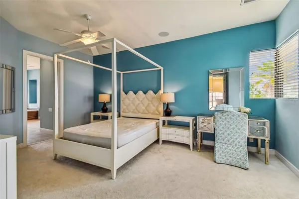 a living room with furniture a ceiling fan and a window