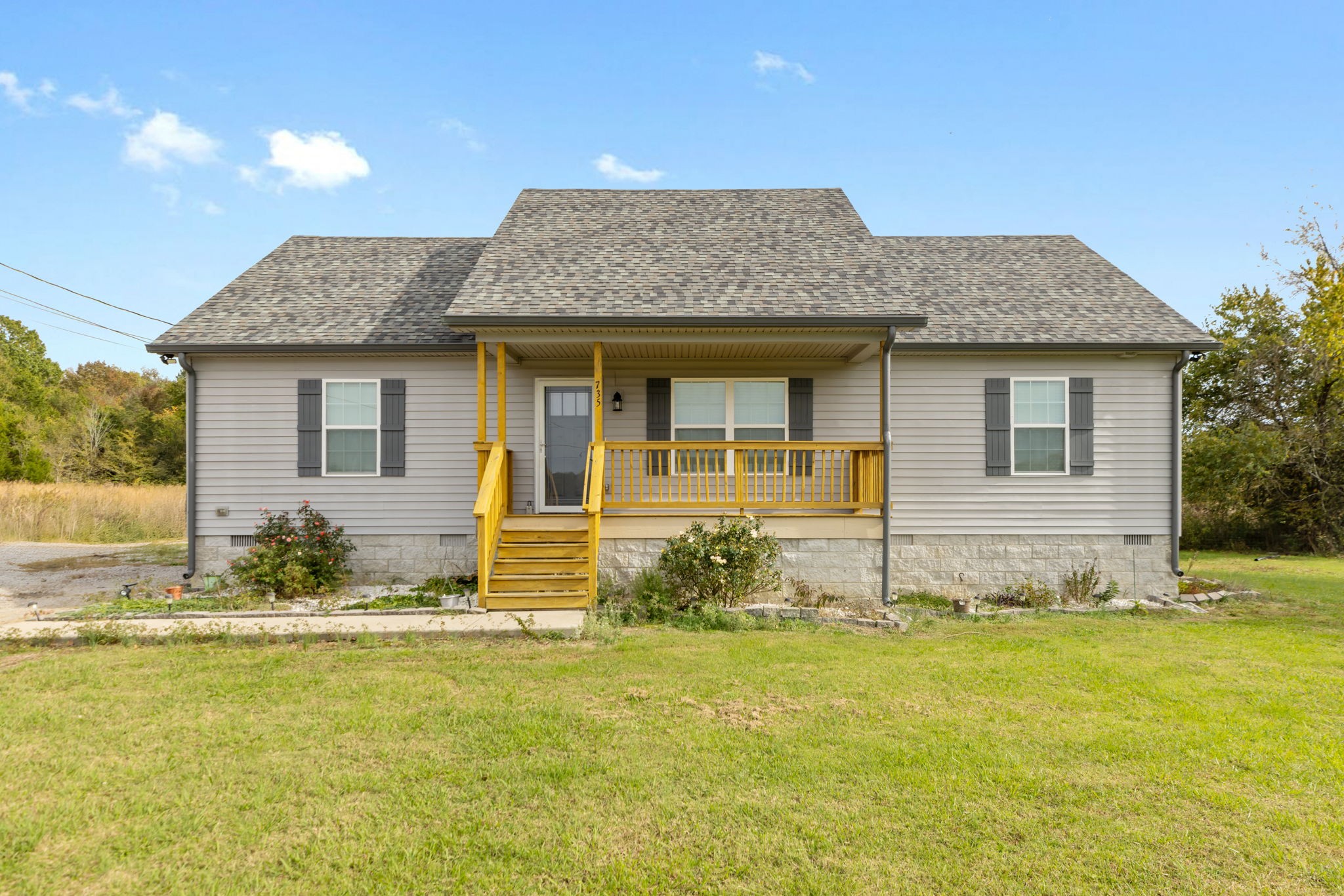 a front view of a house with a yard