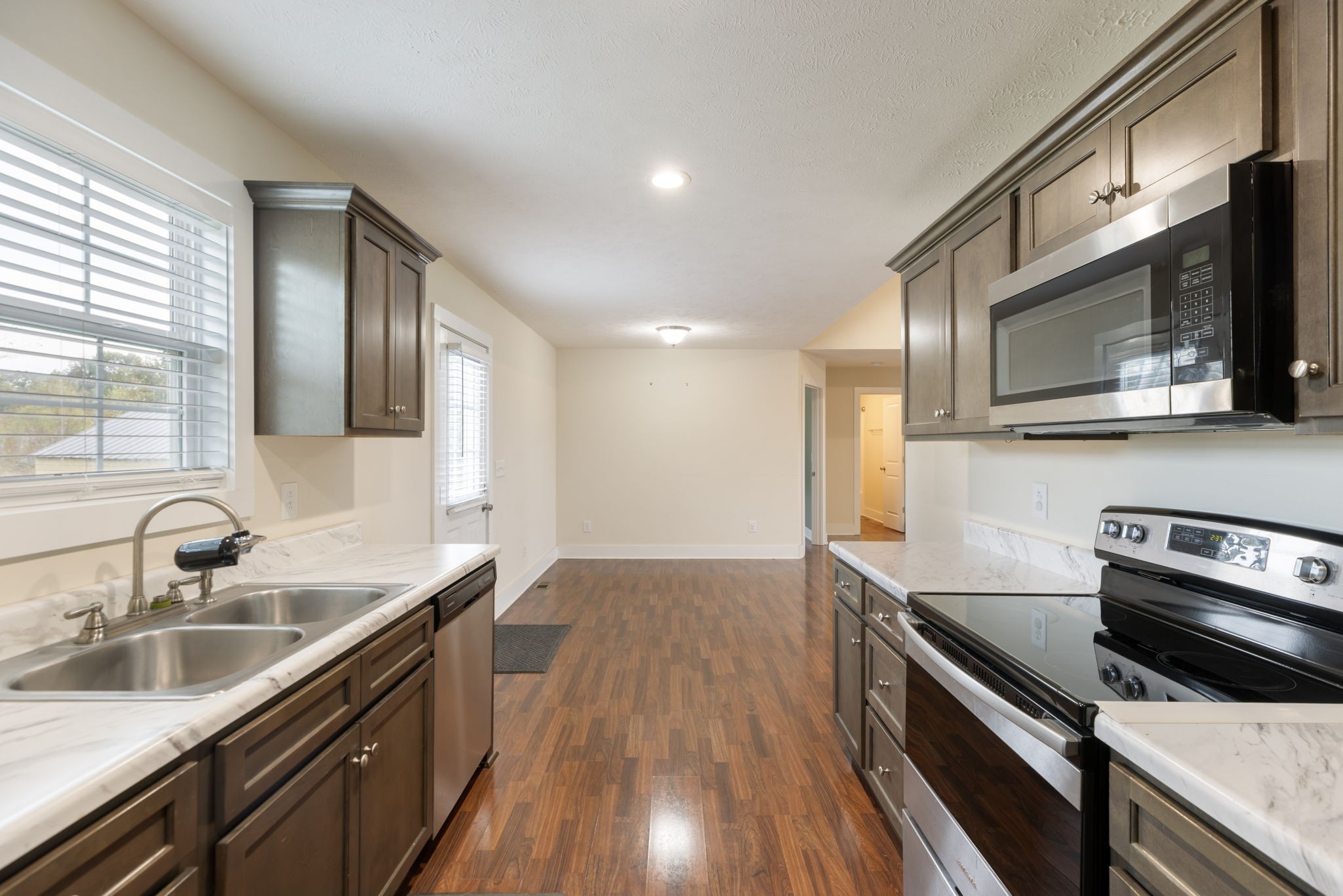 735 Belfast Farmington Road Lewisburg, TN 37091 - Photo 20 of 56 a kitchen with stainless steel appliances a sink dishwasher stove and microwave