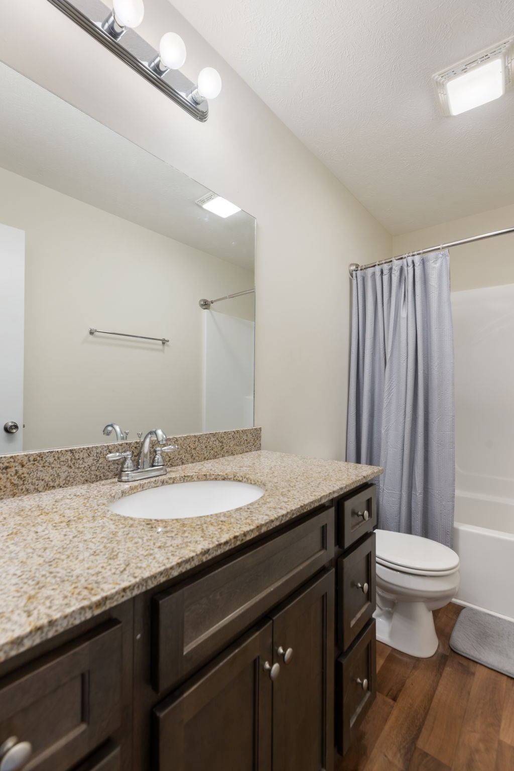 735 Belfast Farmington Road Lewisburg, TN 37091 - Photo 32 of 56 a bathroom with a granite countertop sink a toilet and a mirror