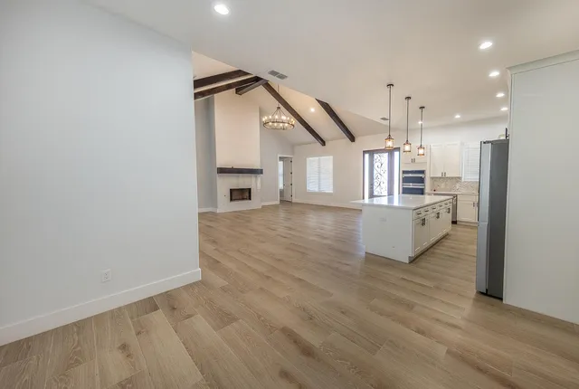 a view of a livingroom with wooden floor and staircase