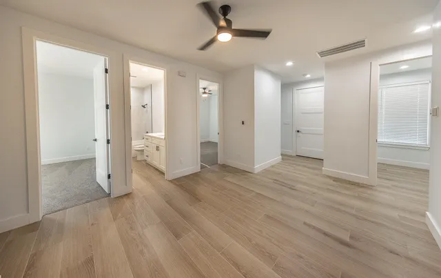 a view of a hallway with wooden floor