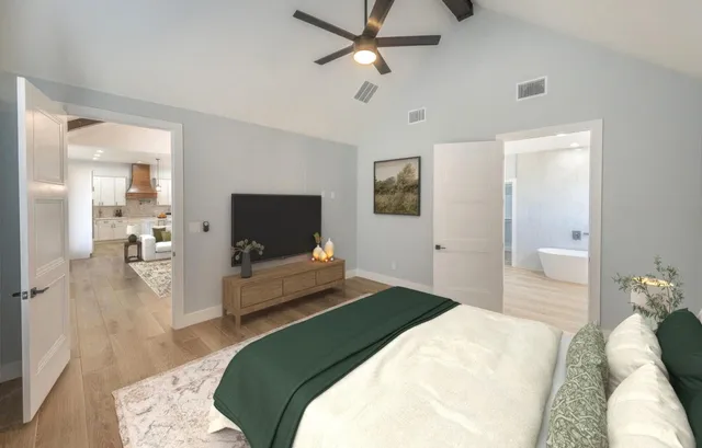 a bedroom with a bed and a flat screen tv