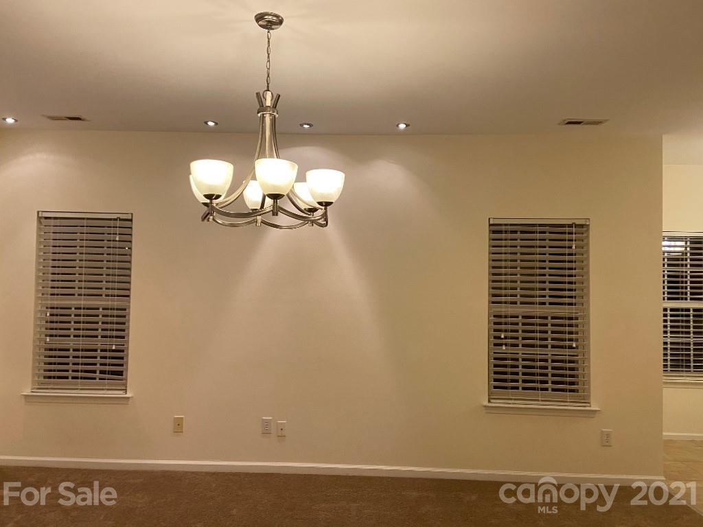 901 Cadogan Court Fort Mill, SC 29708 - Photo 15 of 33 a view of a room with a chandelier fan and windows