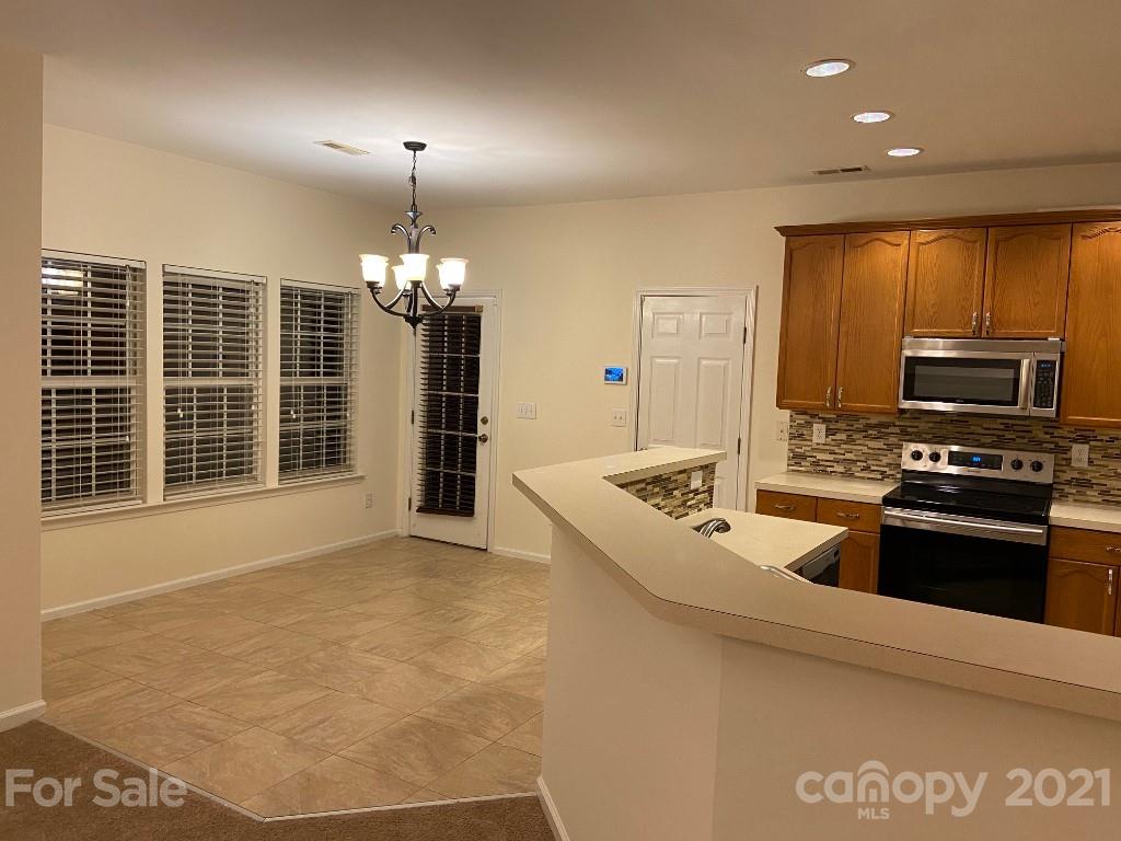 901 Cadogan Court Fort Mill, SC 29708 - Photo 10 of 33 a kitchen with stainless steel appliances granite countertop a sink stove and refrigerator