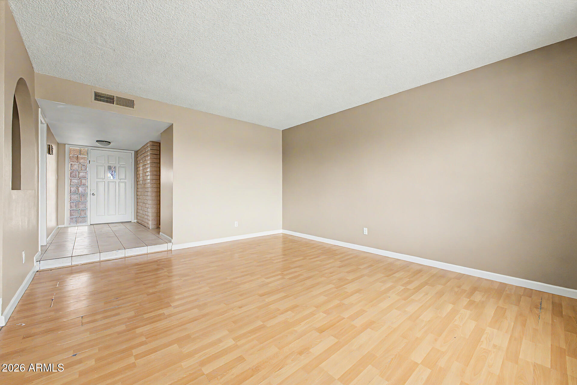 4007 West Mountain View Road Phoenix, AZ 85051 - Photo 6 of 31 a view of an empty room with wooden floor