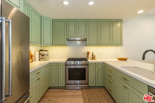 a kitchen with a sink cabinets and stainless steel appliances