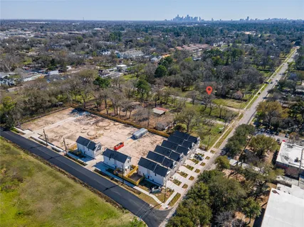 an aerial view of residential houses with outdoor space