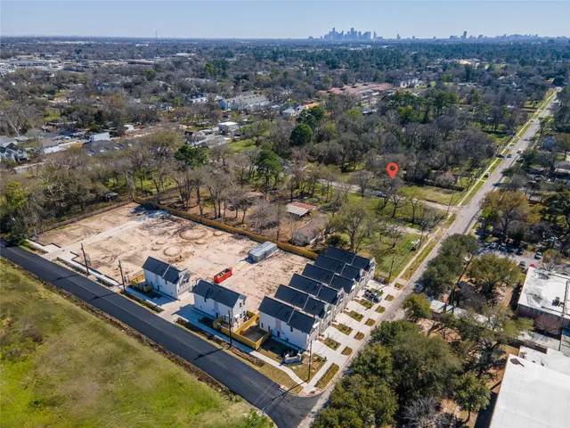 an aerial view of residential houses with outdoor space