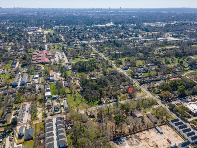 an aerial view of residential houses with city view