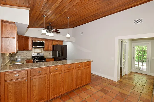 a kitchen with stainless steel appliances a sink and cabinets