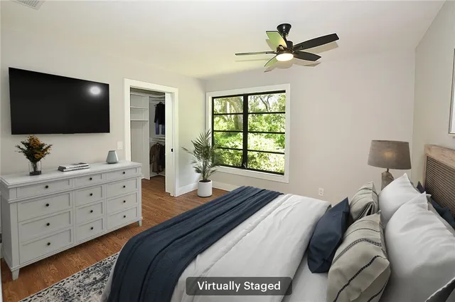 a bedroom with a bed and a flat screen tv