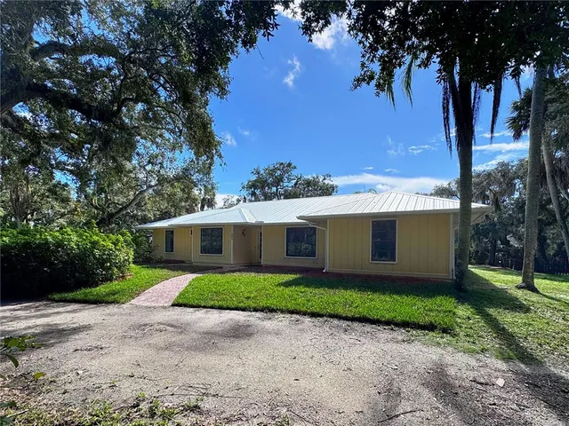 a front view of house with yard and green space