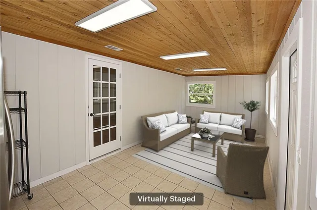 a living room with furniture a window and a table