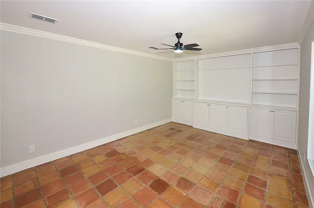 an empty room with a ceiling fan