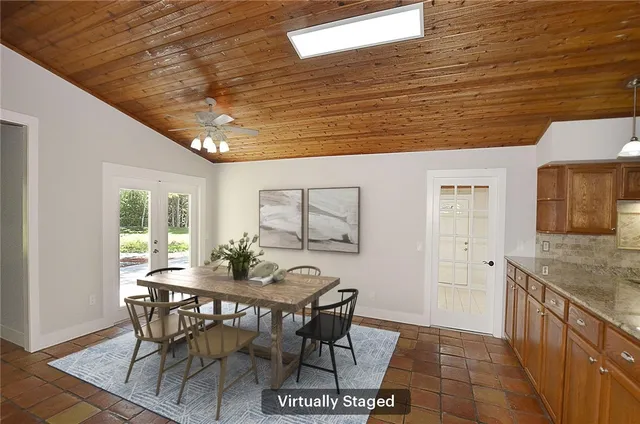 a view of a dining room with furniture and window