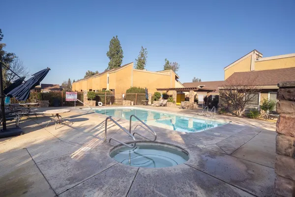 a view of a swimming pool with a patio