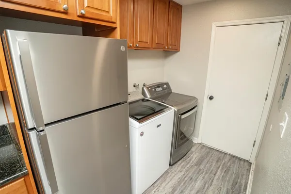 a white refrigerator freezer and a stove sitting inside of a kitchen