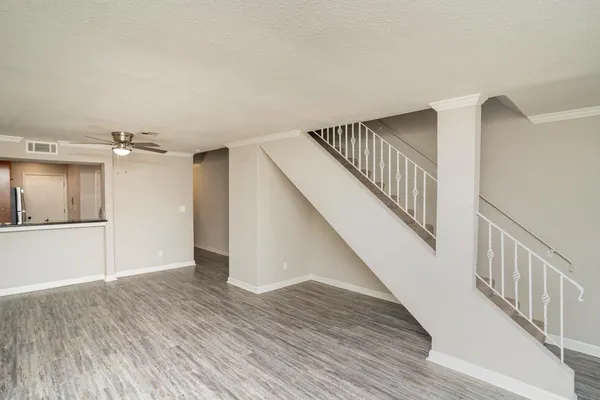a view of hallway with stairs and wooden floor