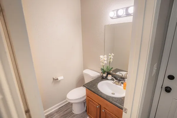 a bathroom with a toilet sink and mirror