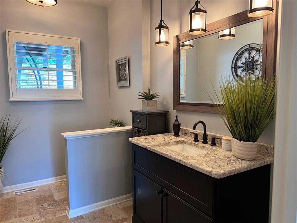 207 Forest Ridge Road Indiana, PA 15701 - Photo 12 of 25 a bathroom with a granite countertop sink a vanity and a mirror