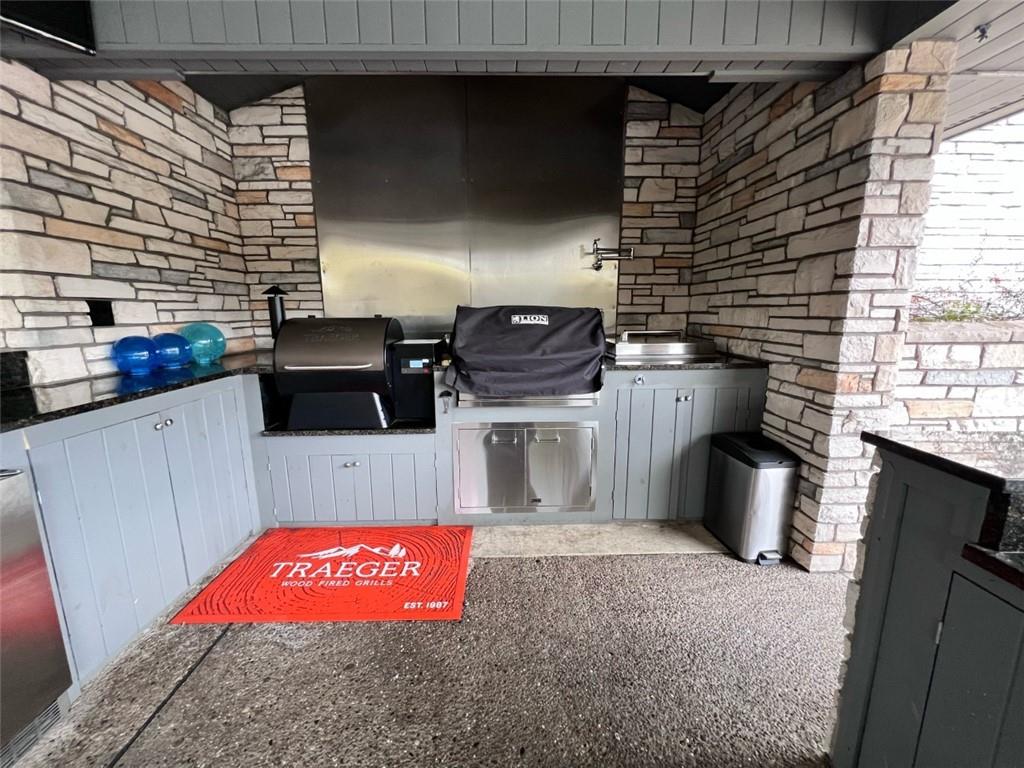 207 Forest Ridge Road Indiana, PA 15701 - Photo 22 of 25 a kitchen with stainless steel appliances granite countertop a stove a sink dishwasher and a microwave oven