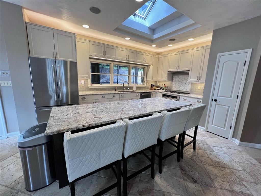 207 Forest Ridge Road Indiana, PA 15701 - Photo 3 of 25 a kitchen with stainless steel appliances granite countertop a stove a refrigerator a sink a dining table and chairs