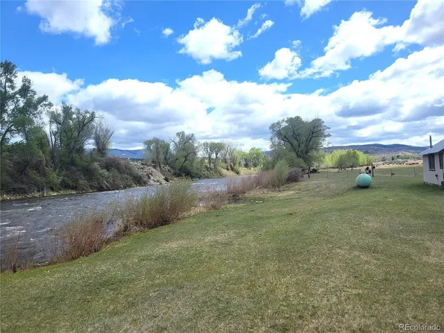 a view of outdoor space with playground and green space