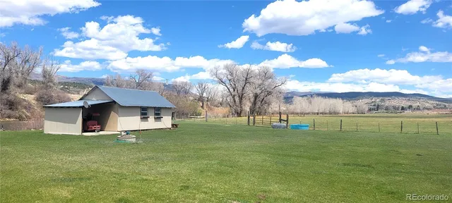 a backyard of a house with outdoor seating
