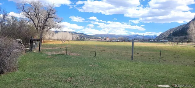 a view of a field with an trees