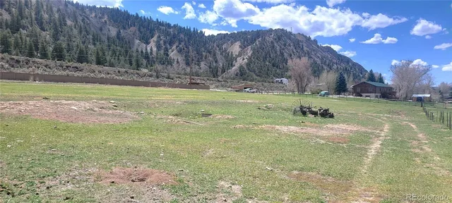 a view of a big yard with an trees