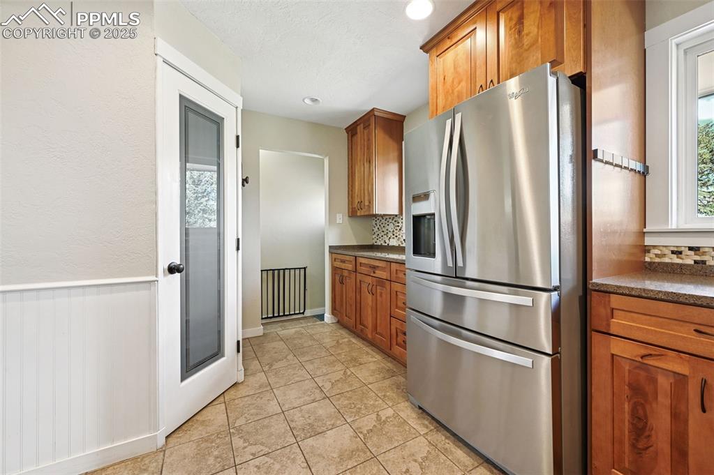 1305 Sunset Road Colorado Springs, CO 80909 - Photo 13 of 50 a kitchen with stainless steel appliances a refrigerator and a stove top oven