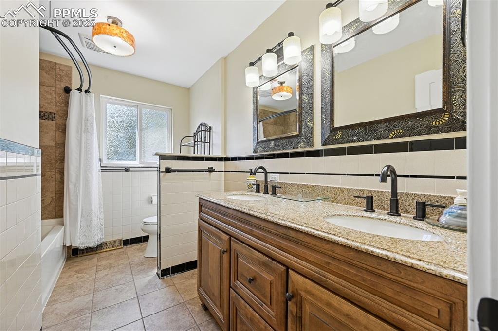 1305 Sunset Road Colorado Springs, CO 80909 - Photo 17 of 50 a bathroom with a sink and a mirror