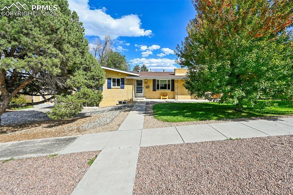 1305 Sunset Road Colorado Springs, CO 80909 - Photo 2 of 50 a view of a house with a yard