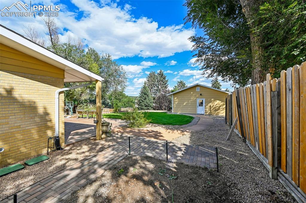 1305 Sunset Road Colorado Springs, CO 80909 - Photo 36 of 50 a backyard of a house with table and chairs
