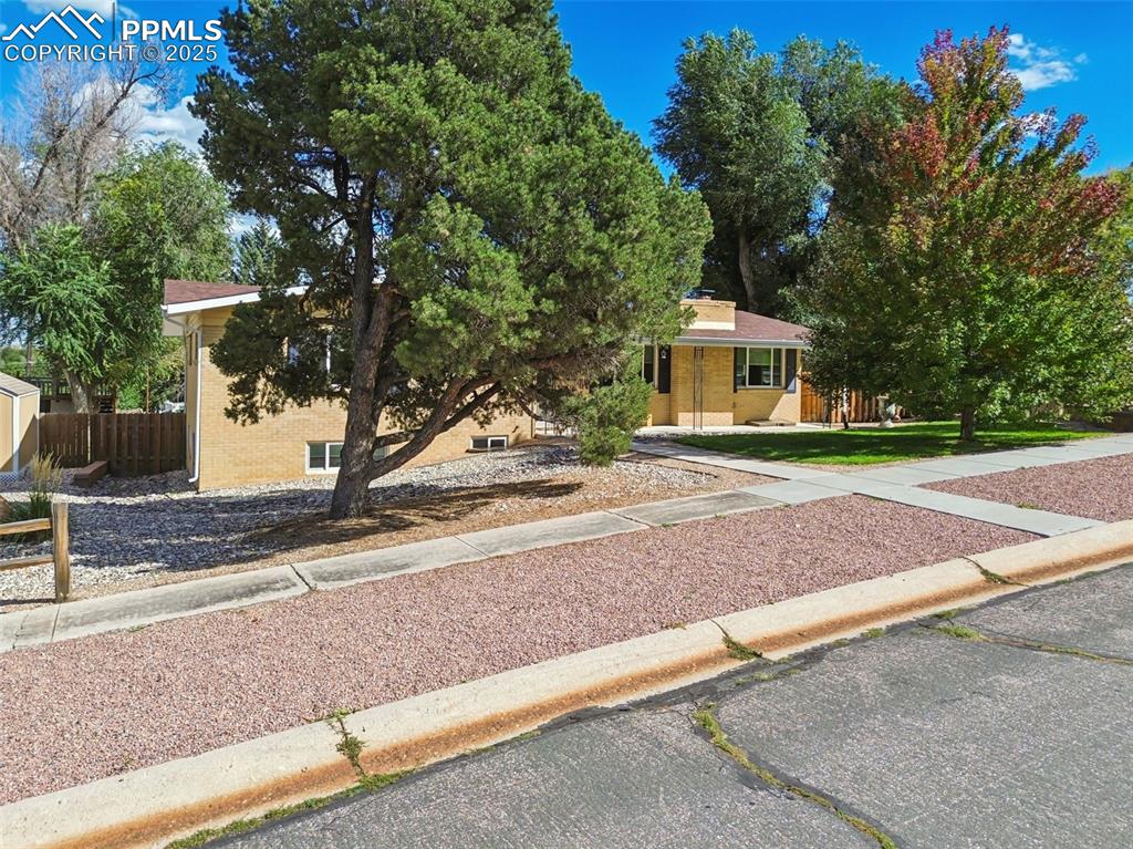 1305 Sunset Road Colorado Springs, CO 80909 - Photo 50 of 50 a front view of a house with a yard