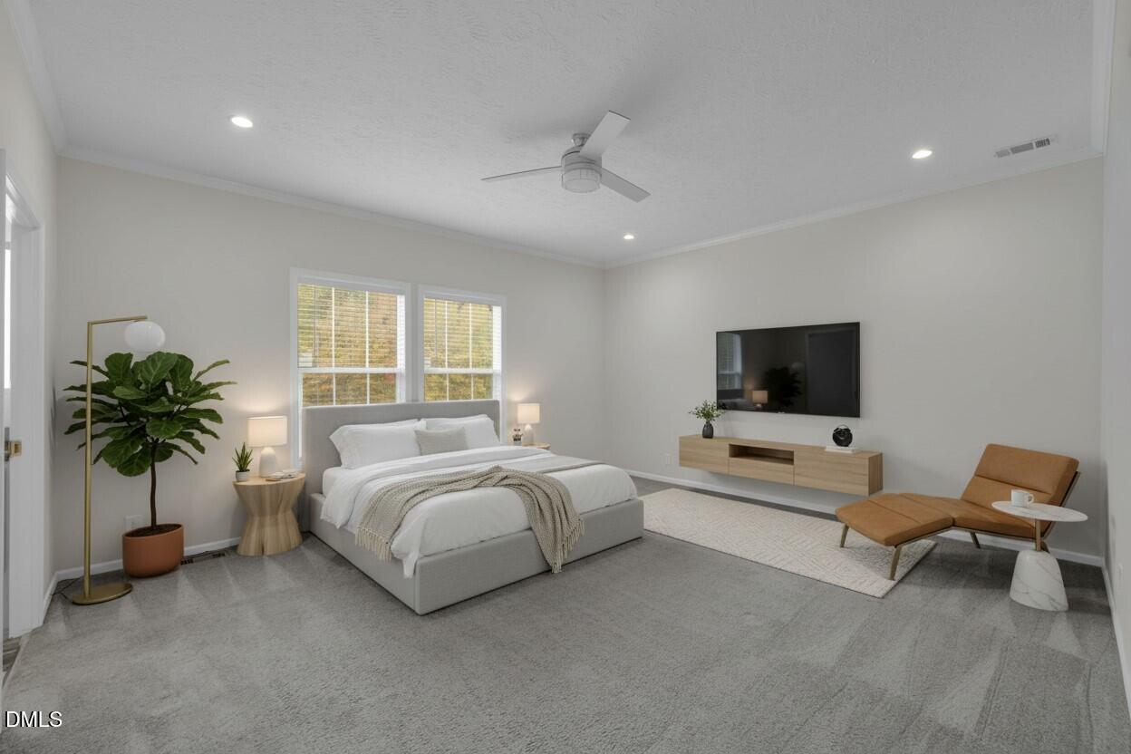 748 Gum Swamp Road Four Oaks, NC 27524 - Photo 15 of 43 a bed room with furniture and a flat screen tv