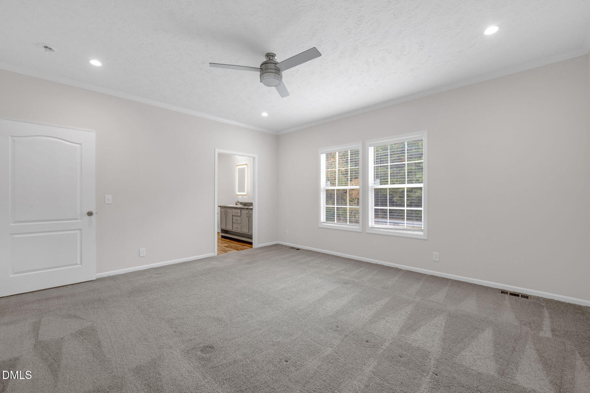 748 Gum Swamp Road Four Oaks, NC 27524 - Photo 17 of 43 an empty room with windows and ceiling fan