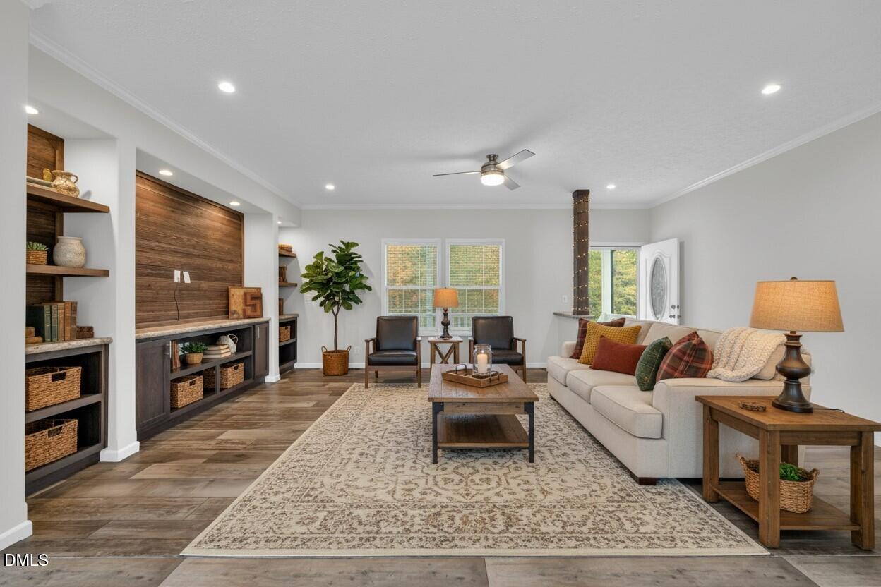 748 Gum Swamp Road Four Oaks, NC 27524 - Photo 2 of 43 a living room with furniture and a flat screen tv