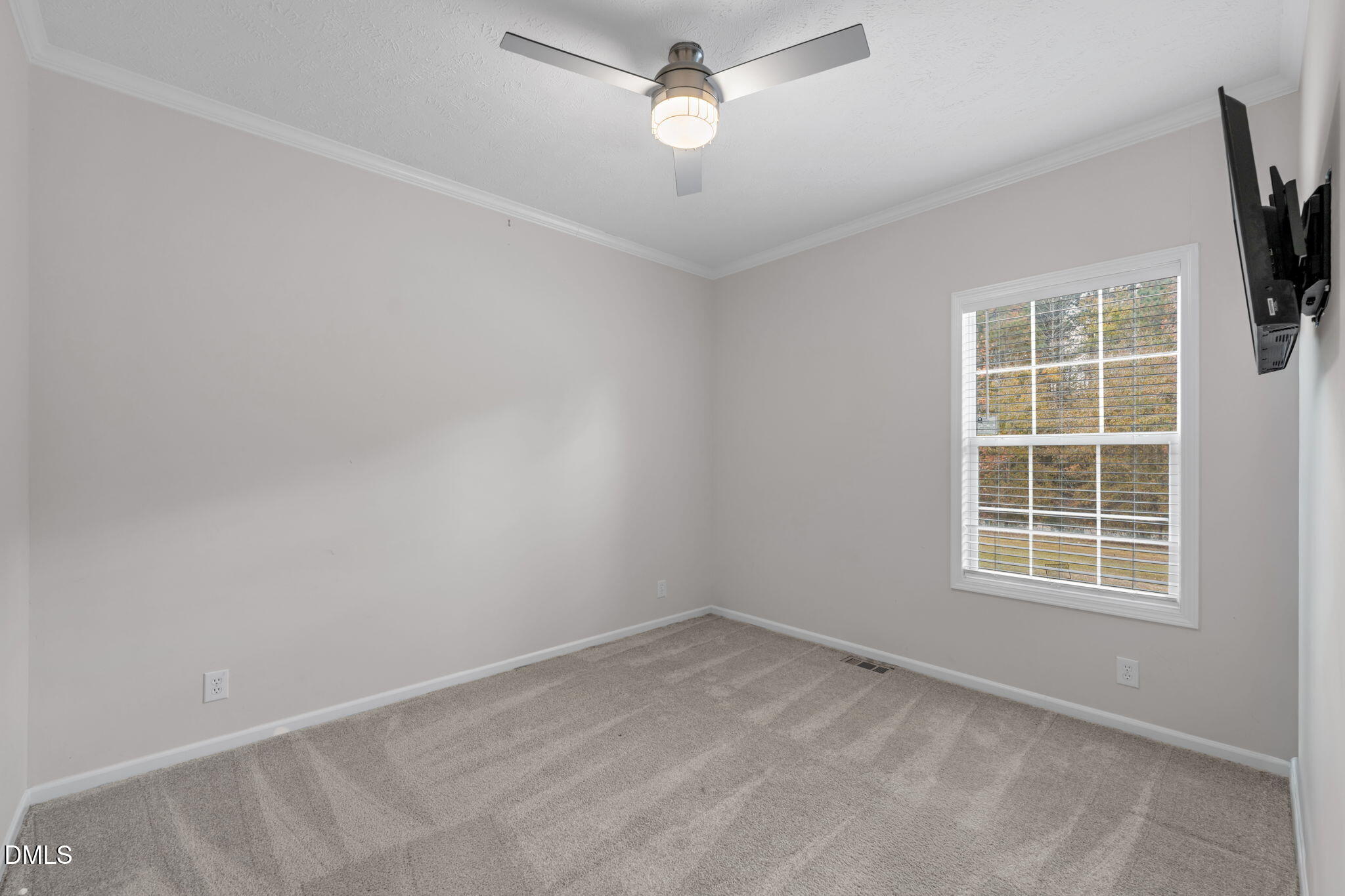 748 Gum Swamp Road Four Oaks, NC 27524 - Photo 29 of 43 an empty room with a window and ceiling fan