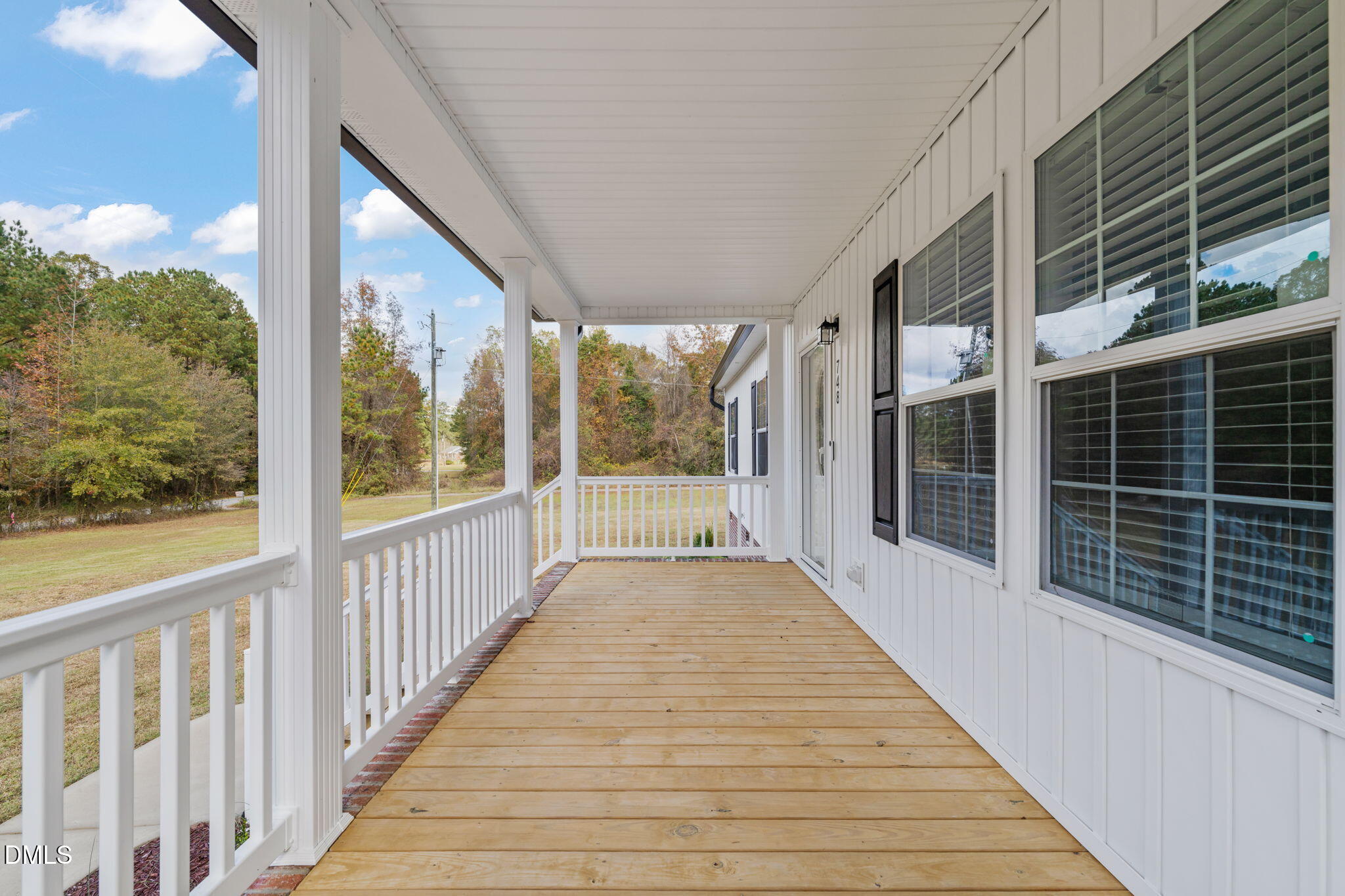 748 Gum Swamp Road Four Oaks, NC 27524 - Photo 39 of 43 a view of porch with wooden floor and iron stairs